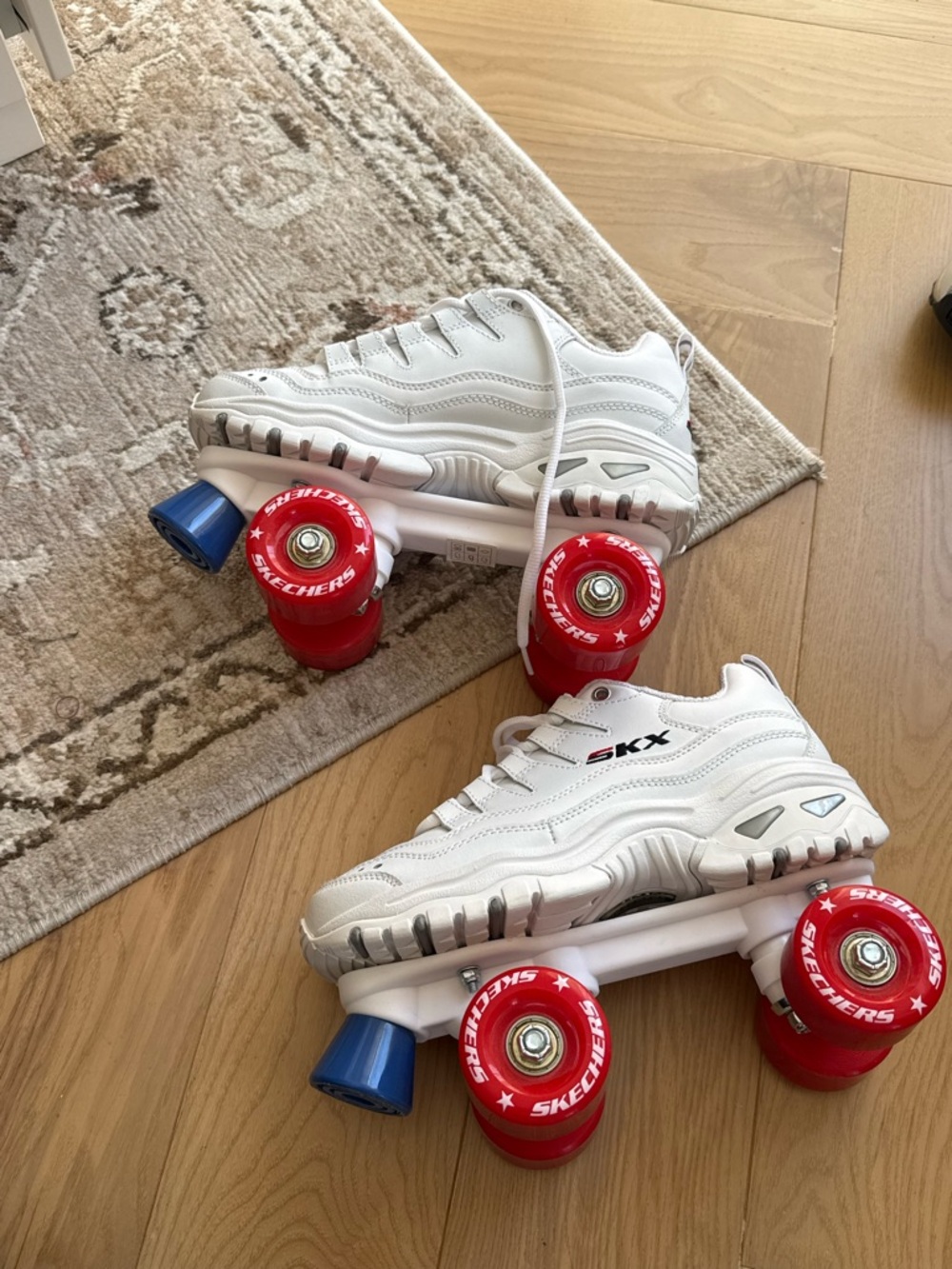 Skechers White Athletic Roller Skates with Red Wheels and Blue Toe Stops